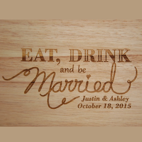 Close up of Eat, Drink and be Married design engraved on a custom cutting board.
