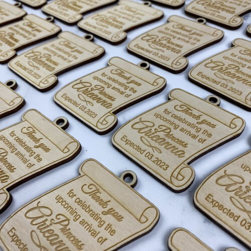 Engraved wood gift tags for a baby shower.