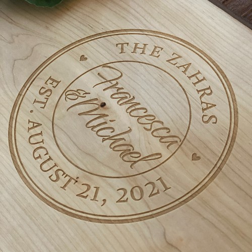 Solid wood charcuterie boards with the couples name and wedding date engraved.