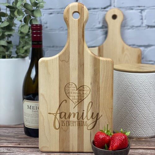 Custom engraved cutting board with family member's names engraved in the heart.