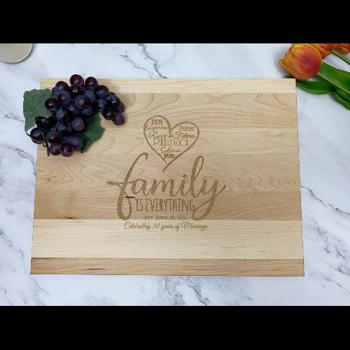 Rectangular cutting board with family design and custom saying engraved in the center.