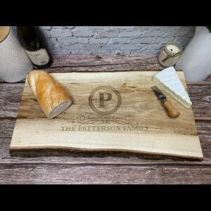 Live edge charcuterie board, made in Canada, with a personalized engraving used for a Realtor closing gift.