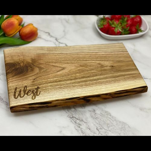 Live edge engraved charcuterie board with a family name in the corner. Made in Canada.