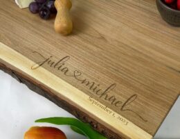 Engraved cheese board with the couples names and wedding date in the corner.