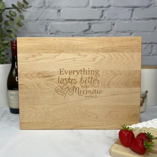 Rectangular cutting board engraved for a gift for Grandma with children's names engraved as part of the design.