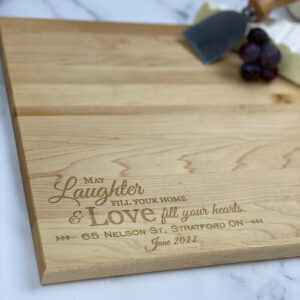 Engraved cutting boards with a love & laughter saying.