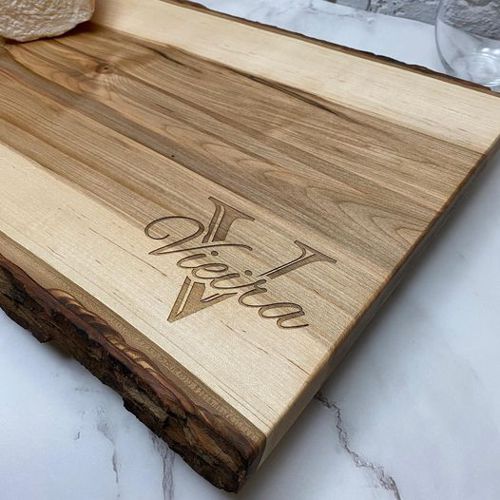 Live edge cheeseboard with an initial and name engraved in the corner.