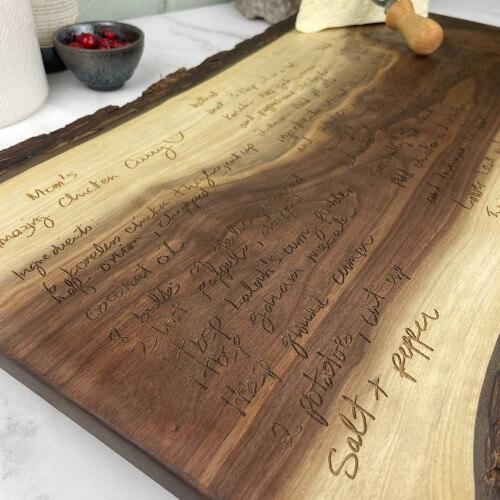 Close up of a recipe engraved on a solid wood charcuterie board.