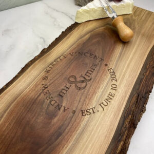 Charcuterie boards personalized with a wedding design. The names and date are surrounding the couples titles.