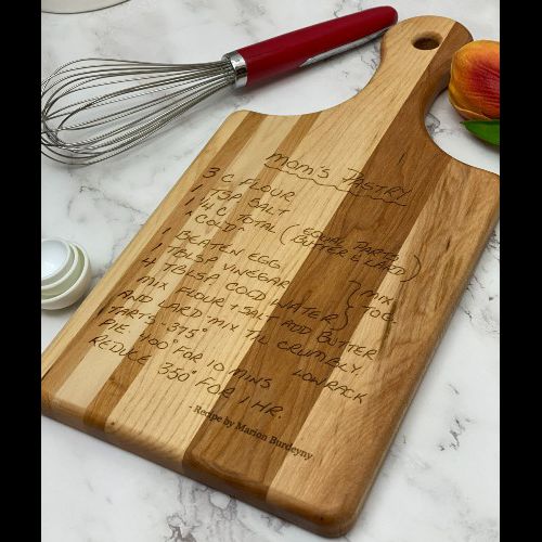 Handwritten recipe engraved on a paddle style cutting board.