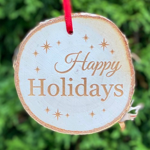 Happy Holidays engraved on a rustic birch ornament.