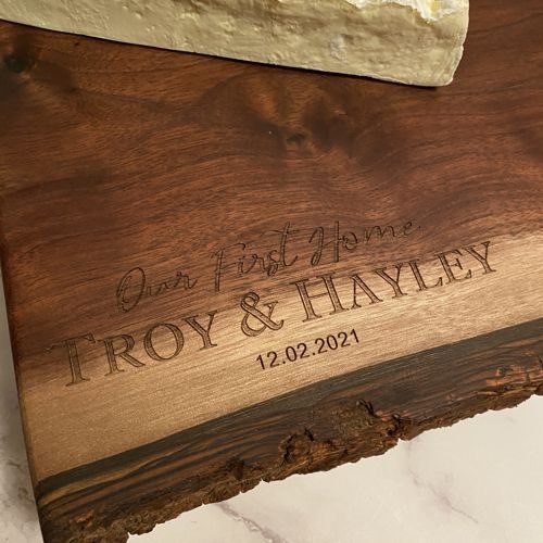 Close up of engraving on a walnut board, showing the subtlety of the engraving.