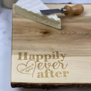 Personalized charcuterie board with happily ever after and the couples names engraved in the corner.