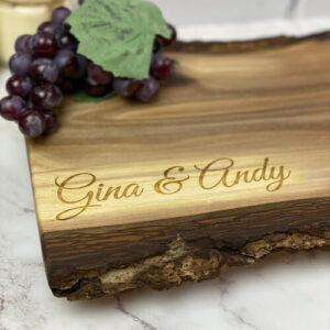 A simple engraving of the first names engraved on a charcuterie board, made in Canada.