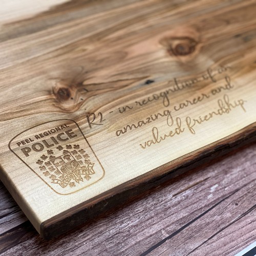 Custom charcuterie boards can be engraved with a logo. This Peel Regional Police logo engraved beautifully.